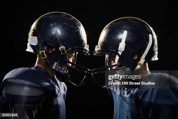 boys in football uniforms - american football player studio stock pictures, royalty-free photos & images