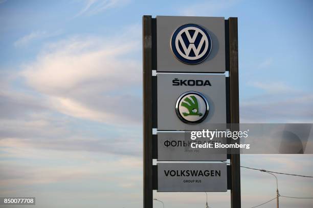 The logos of Volkswagen AG and Skoda Auto AS sit on display outside the Volkswagen Group Rus OOO plant in Kaluga, Russia, on Tuesday, Sept. 19, 2017....