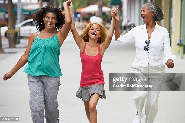 multi-generational women holding hands - skipping along stock pictures, royalty-free photos & images