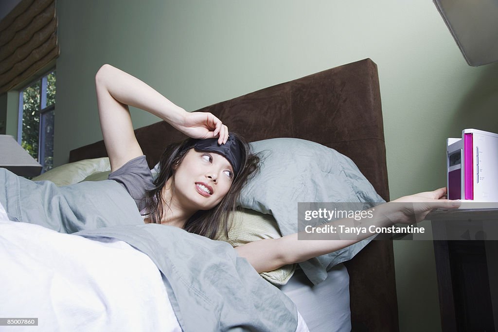 Woman waking to alarm clock