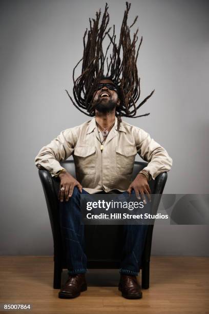 african man swinging dreadlocks - ラスタ ストックフォトと画像