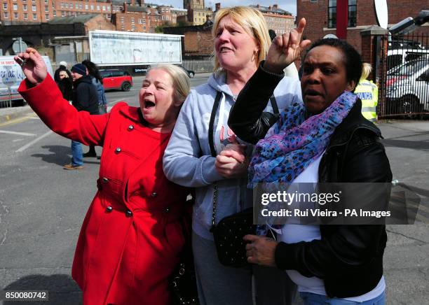 Members of the public react as a police van believed to be transporting Mick or Mairead Philpott leaves Nottingham Crown Court. Mick Philpott and his...