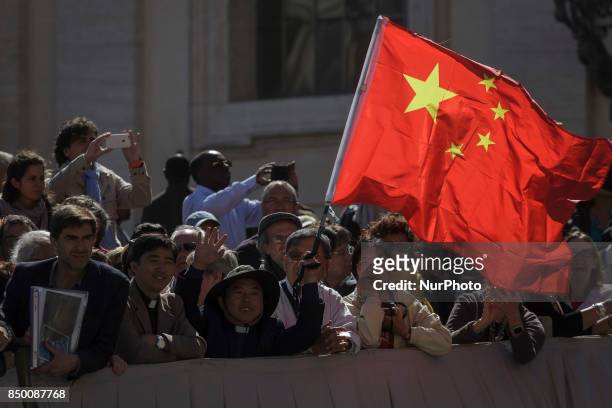 Faithful holds a Chiinese flag as Pope Francis leads his Weekly General Audience in St. Peter's Square in Vatican City, Vatican on September 20,...