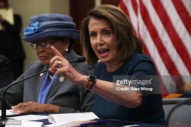 House Minority Leader Rep. Nancy Pelosi speaks as Rep. Alma Adams listens during a roundtable discussion September 20, 2017 on Capitol Hill in...
