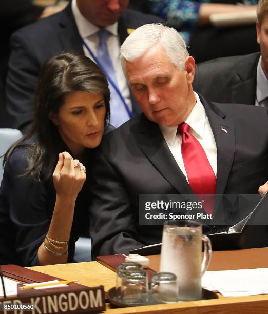 Vice President Mike Pence confers with U.S. Ambassador to the United Nations Nikki Haley at a Security Council meeting during the 72nd U.N. General...