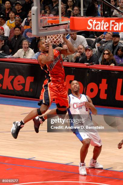 Kelenna Azubuike of the Golden State Warriors puts up a shot while Fred Jones of the Los Angeles Clippers looks on during their game at Staples...