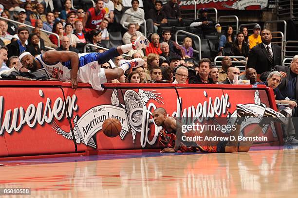 Baron Davis of the Los Angeles Clippers and C.J. Watson of the Golden State Warriors chase after a loose ball during their game at Staples Center on...