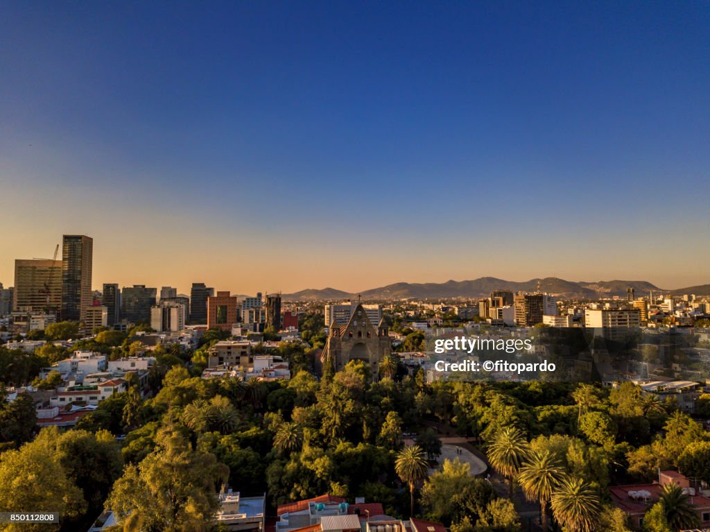 Aerial sunset view of Polanco skyline discovering the sun