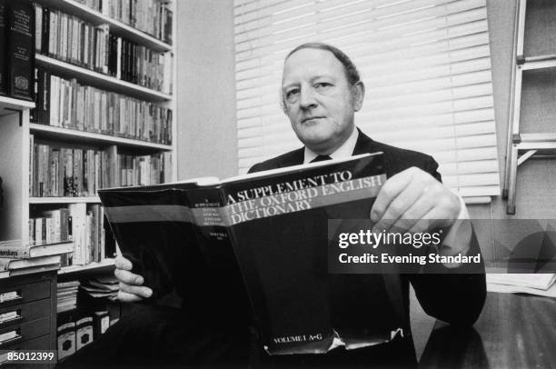 English writer and broadcaster Robert Robinson holding the first volume of 'A Supplement To The Oxford English Dictionary', 24th March 1977.