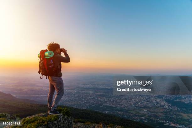 un ragazzo che guarda attraverso il binocolo - canocchiale foto e immagini stock