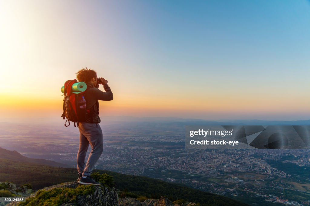 A guy watching through binoculars