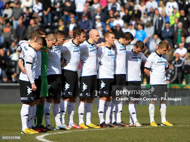 Derby County players observe a minutes silence in memory of the six children who lost there lives in a house fire on Victory Road prior to the npower...
