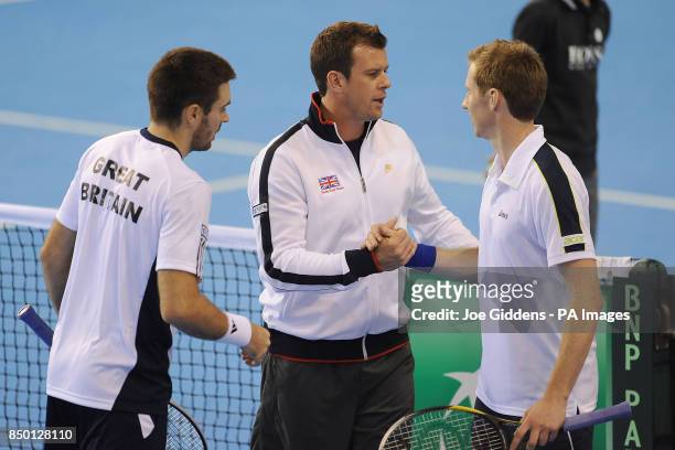 Great Britain coach Leon Smith congratulates Colin Fleming and Jonny Marray after the Davis Cup match against Russia's Igor Kunitsyn and Victor...