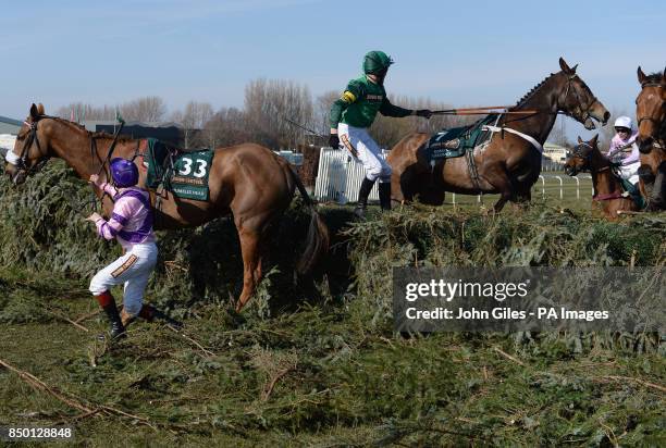 Mumbles Head and Jamie Moore block Barry Geraghty and Roberto Goldback at the final fence in the john Smith's Grand National during Grand National...