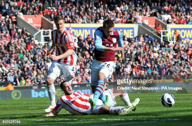 Stoke City's Marc Wilson tackles Aston Villa's Andreas Weimann during the Barclays Premier League match at the Britannia Stadium, Stoke on Trent.