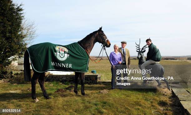 Auroras Encore with trainers Harvey and Sue Smith and winning jockey Ryan Mania sitting on a stag during the winners photocall at Craiglands Farm,...