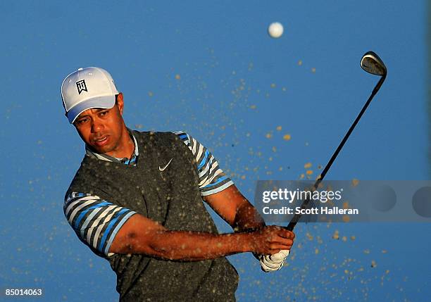 Tiger Woods hits a bunker shot during a practice round prior to the start of the Accenture Match Play Championship at the Ritz-Carlton Golf Club at...