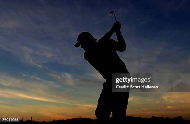 Phil Mickelson hits a shot on the practice ground during a practice round prior to the start of the Accenture Match Play Championship at the...