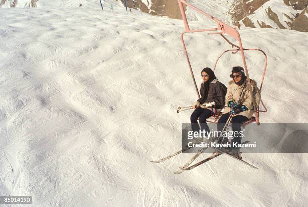 Young women on a ski lift at the Shemshak ski resort in the Alborz mountains north-east of Tehran, 16th February 1999. Iranian Islamic law prohibits...
