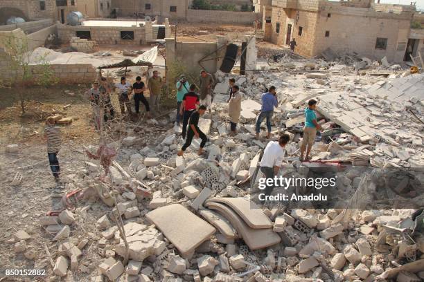 People inspect the scene after Abu Bakr As-Siddiq Mosque was hit with an air strike in Idlib, Syria on September 20, 2017. It is reported that at...