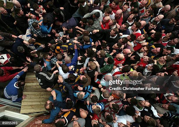 Fence collapses under pressure as rival teams the Up'ards and Down'ards battle for the ball in the annual Shrove Tuesday 'no rules' football match on...