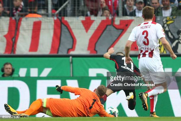 Timo Horn of Koeln fouls Mijat Gacinovic of Frankfurt which results in a penalty for Frankfurt during the Bundesliga match between 1. FC Koeln and...