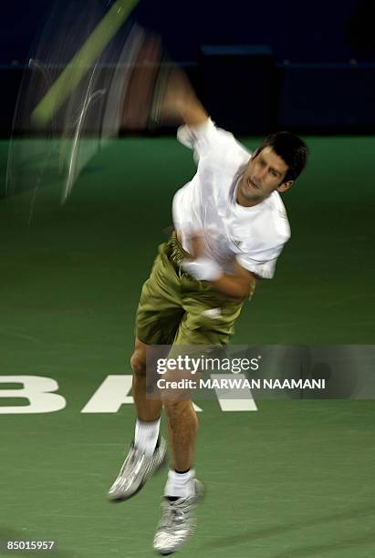 Serbia's Novak Djokovic returns the ball to Italy's Flavio Cipolla during their singles tennis match on the second day of the ATP Dubai tennis...