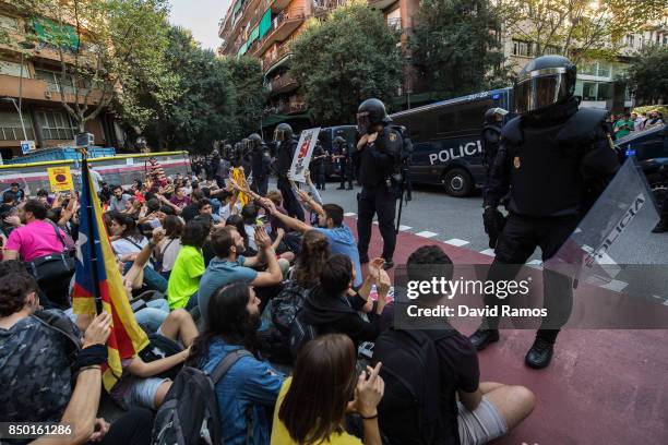 Spain National riot police officers stand guard outside the Catalan Pro-Independence Lefty party CUP headquarter as demonstrators block the road on...