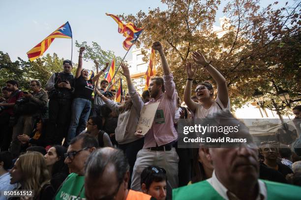 People demonstrate outside the Catalan Vice-President and Economy office as police officers holds a searching operation inside on September 20, 2017...