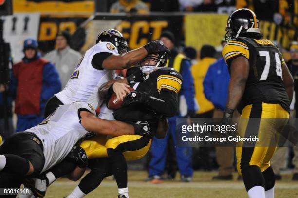 Defensive lineman Marques Douglas of the Baltimore Ravens sacks linebacker Ben Roethlisberger of the Pittsburgh Steelers with help from linebacker...