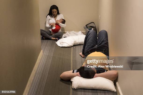 Adriana Rosado Jorge Diana and their 2-month old Jorge Nicolas, who live in Guaynabo, are guests at the Ciqala hotel as they wait in the hallway...