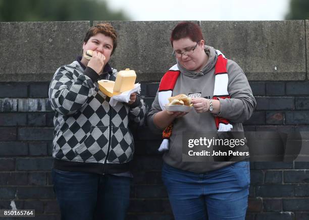 Manchester United fans arrive ahead of the Carabao Cup Third Round match between Manchester United and Burton Albion at Old Trafford on September 20,...