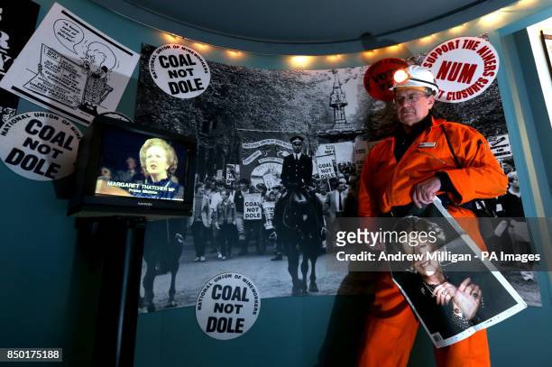 Jim Cornwall former miner and now guide at the National Mining Museum for Scotland at the Lady Victoria Colliery in Newtongrange holds a newspaper as...