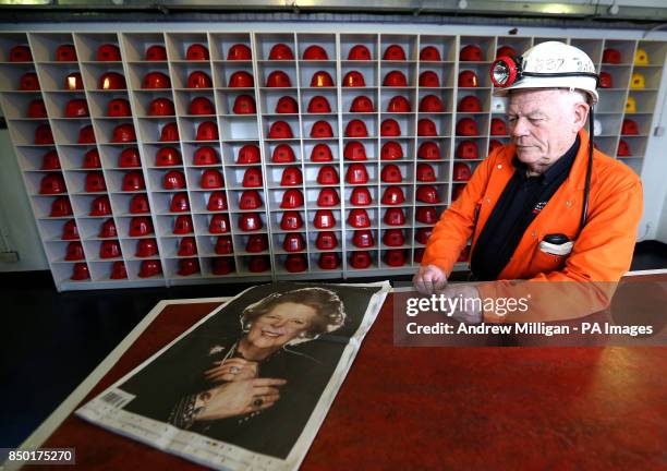 John Kane former miner and now guide at the National Mining Museum for Scotland at the Lady Victoria Colliery in Newtongrange holds a newspaper as he...