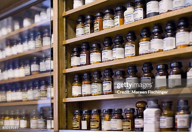 medical bottles and poisons in pharmacy shelves - bottle shop stock-fotos und bilder