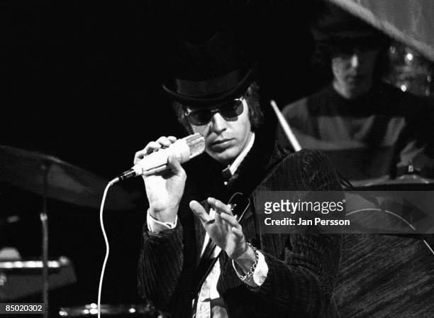 Photo of Scott WALKER and WALKER BROTHERS; Scott Walker performing on TV show - singing to camera, wearing sunglasses