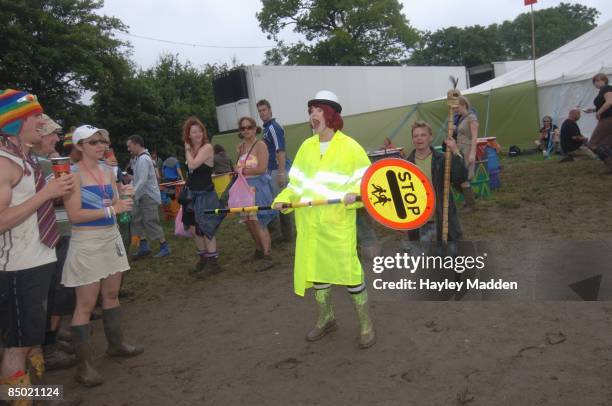 Photo of GLASTONBURY, Lollipop woman in mud at Glastonbury Festival