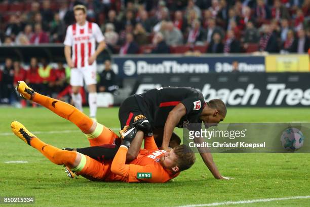 Sebastien Haller of Frankfurt falls over goalkeeper Timo Horn of Koeln during the Bundesliga match between 1. FC Koeln and Eintracht Frankfurt at...