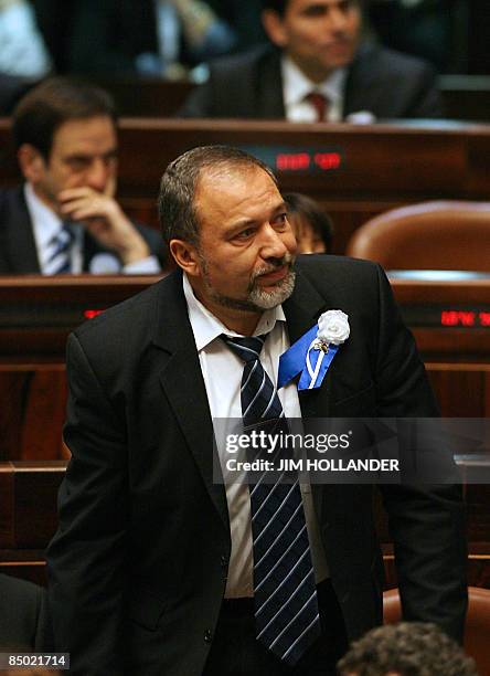 Israeli far-right Yisrael Beitenu party leader Avigdor Lieberman stands to be sworn in as a member of Israel's new knesset during its inaugural...