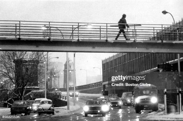 Charles Street Circle in Boston glistens as vehicles pass through rain and slush coming off the Longfellow Bridge in the early morning on Dec. 17,...