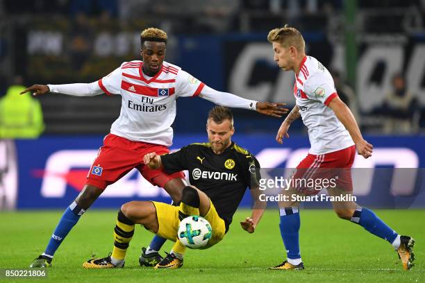 Gideon Jung of Hamburg , Andrej Yarmolenko of Dortmund and and Lewis Holtby of Hamburg fight for the ball during the Bundesliga match between...
