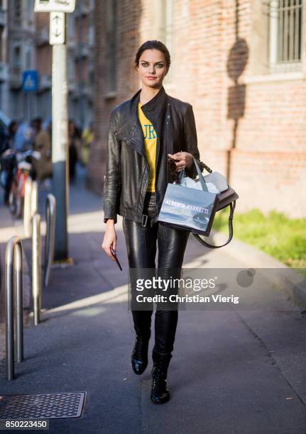 Brazilian model Barbara Fialho wearing black leather jacket and leather pants is seen outside Alberta Ferretti during Milan Fashion Week...
