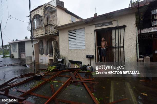 Residents of San Juan, Puerto Rico, deal with damages to their homes on September 20 as Hurricane Maria batters the island. Maria slammed into Puerto...