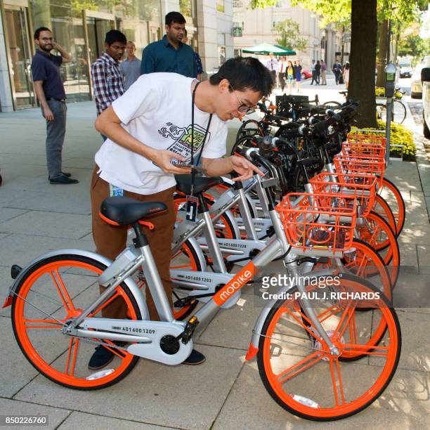 Man tries to rent a Mobike on the streets of Washington, DC, on September 20 after about 200 of the bicycles that are rented via an app that finds...