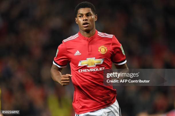 Manchester United's English striker Marcus Rashford celebrates scoring the opening goal during the English League Cup third round football match...