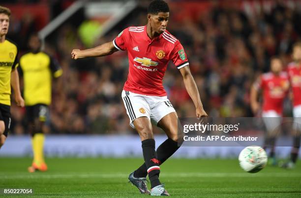 Manchester United's English striker Marcus Rashford scores the opening goal during the English League Cup third round football match between...