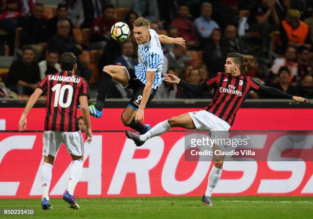 Andre Silva of AC Milan and Bartosz Salamon of Spal compete for the ball during the Serie A match between AC Milan and Spal at Stadio Giuseppe Meazza...