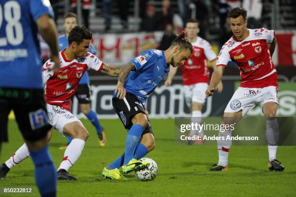 Romario Pereira Sipiao and Melker Hallberg of Kalmar FF compete with Pontus Silfwer of Halmstad BK for the ball at Orjans Vall on September 20, 2017...