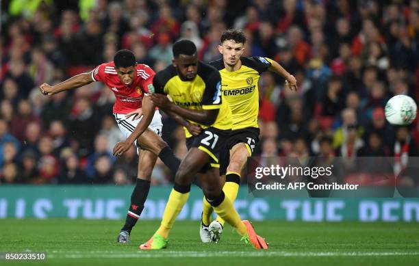 Manchester United's English striker Marcus Rashford scores his, and his team's second goal during the English League Cup third round football match...