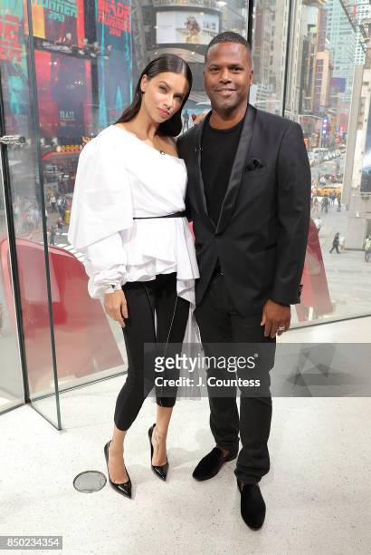 Model Adriana Lima poses for a photo with A. J. Calloway during her visit to 'Extra' at their New York Studios at H&M Times Square on September 20,...
